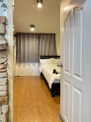 a bedroom with a white bed and a window at Chubbi 5 Room10 in Bang O
