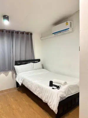 a small bedroom with a bed with a white sheets and aasser at Chubbi 5 Room10 in Bang O