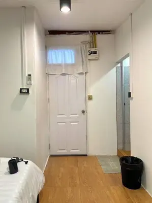 a room with a bed and a door with a window at Chubbi 5 Room10 in Bang O