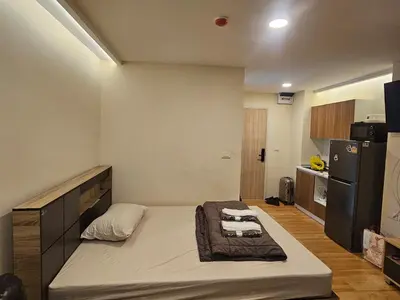 a small room with a bed in a kitchen at forest by Bangboon by Parisa in Sathani Wat Sing
