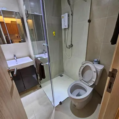 a bathroom with a shower and a toilet and a sink at forest by Bangboon by Parisa in Sathani Wat Sing