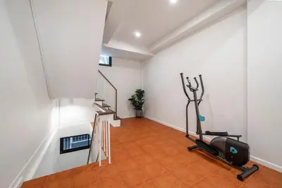 a room with a gym with a treadmill and stairs at 4BR Walk to Chinatown, MRT Luggage Dropoff in Bangkok