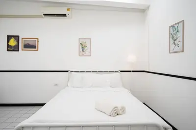 a white room with a bed in it at XX GO INN MRT Hua Lamphong China Town in Bangkok