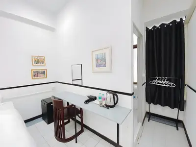 a white room with a desk and a black shower curtain at XX GO INN MRT Hua Lamphong China Town in Bangkok