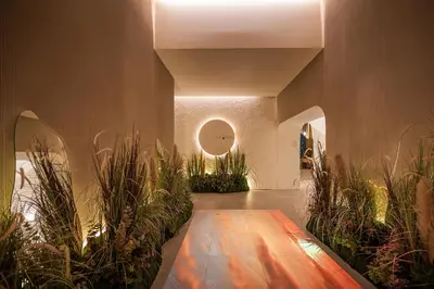 a hallway with potted plants in a building at Somerset Sukhumvit 71 Bangkok in Bangkok