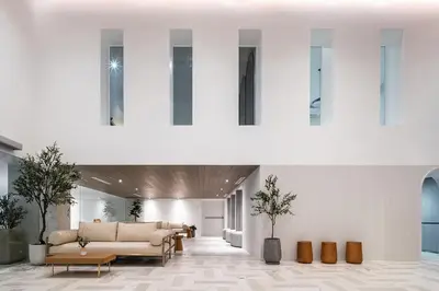 a lobby with couches and tables in a building at Somerset Sukhumvit 71 Bangkok in Bangkok
