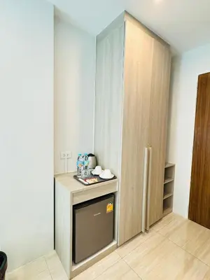 a small kitchen with a counter and a cupboard at Icon Dome Bangkok in Bangkok