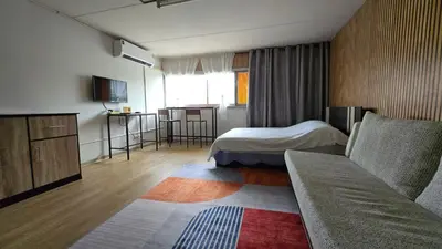a hotel room with a bed and a couch at อิมแพ็ค เมืองทองธานี ห้องพักรายวัน Popular Condo T8 in Nonthaburi
