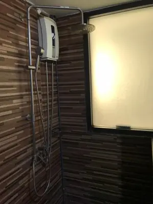 a shower in a bathroom with a screen at Rod Fai Fah Apartment in Bangkok
