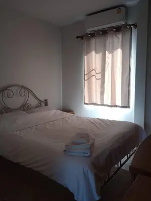 a bedroom with a bed with towels on it at ที่พักนักเดินทาง ภู่ระหงษ์ in Bangkok