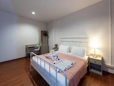 a bedroom with a bed and a desk at The City Yaowarat in Samphanthawong