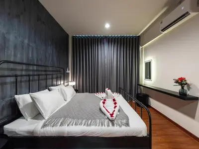 a bedroom with a bed with a stuffed animal on it at The City Yaowarat in Samphanthawong