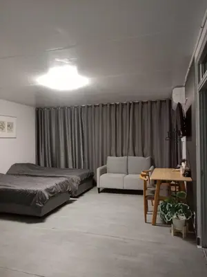 a bedroom with a bed and a couch and a table at Popular Muang Thong Thani Condo, Building T9, Floor 8, Room 13 in Pak Kret
