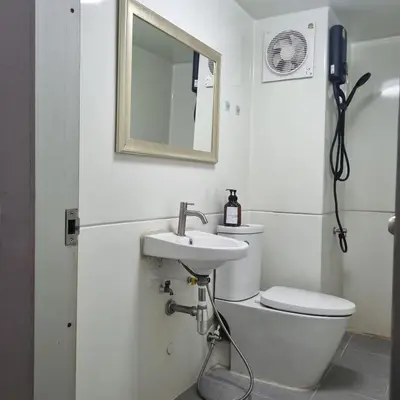 a bathroom with a toilet and a sink and a mirror at Popular Muang Thong Thani Condo, Building T9, Floor 8, Room 13 in Pak Kret