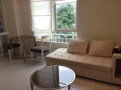 a living room with a couch and a table and a window at Condo near Iconsiam The Bangkok Sathorn-Taksin Corner Room in Godown