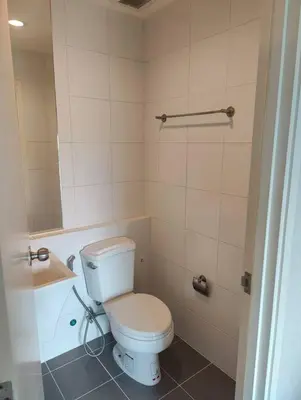 a bathroom with a white toilet and a sink at Aspire Rattanatibet 2 at MRT Purple Line in Nonthaburi