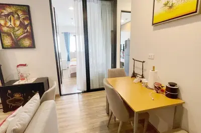 a living room with a table and a couch at Niche Mono 2 Bedroom next to BTS Bearing in Samut Prakan