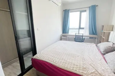 a small bedroom with a bed and a window at Niche Mono 2 Bedroom next to BTS Bearing in Samut Prakan