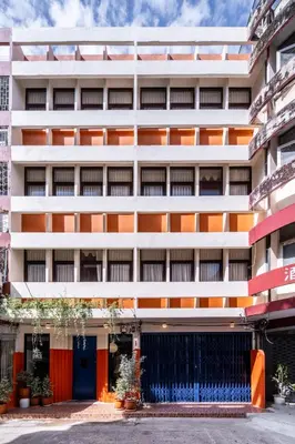 an external view of a building with orange and white at Blu Dock Restel Bangkok in Bangkok