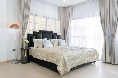 a bedroom with a large bed with a large window at Psalms 23 Residence in Bangkok