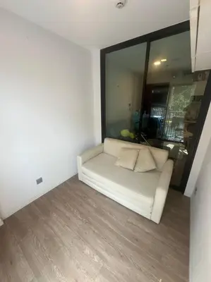 a white couch in a room with a window at Great Value Apartment in Bang Khen
