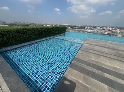 a swimming pool on top of a building at Great Value Apartment in Bang Khen