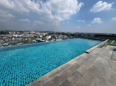 a large swimming pool on top of a building at Great Value Apartment in Bang Khen