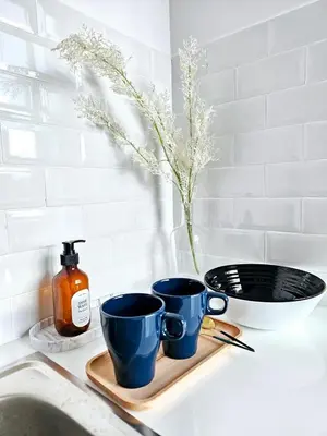 two blue cups sitting on a tray next to a sink at Midtown Duplex Ratchayothin in Bangkok