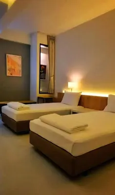 two beds in a hotel room with two beds at Hello my friend in Bang Bua Thong Railway Station