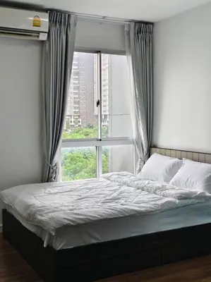a bed in a room with a window at Fully Furnished Apartment Close to MRT Pool n Gym in Nonthaburi