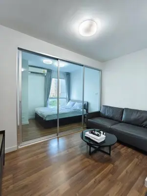 a living room with a couch and a bed at Fully Furnished Apartment Close to MRT Pool n Gym in Nonthaburi