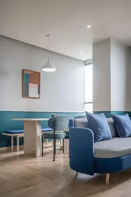 a living room with a couch and a table at The Quarter Ramkhamhaeng by UHG in Bangkok