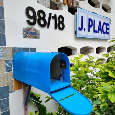 a blue bench on the side of a building at Jplace 101 Spacious Apartment with free Wi-fi in Bangkok