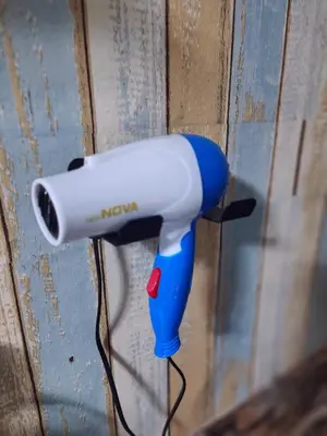 a blow dryer is hanging on a wall at Jplace 101 Spacious Apartment with free Wi-fi in Bangkok