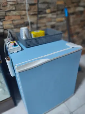 a blue refrigerator with a basket on top of it at Jplace 101 Spacious Apartment with free Wi-fi in Bangkok