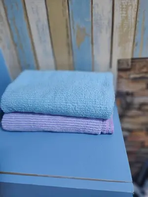 two stacks of towels sitting on top of a table at Jplace 101 Spacious Apartment with free Wi-fi in Bangkok