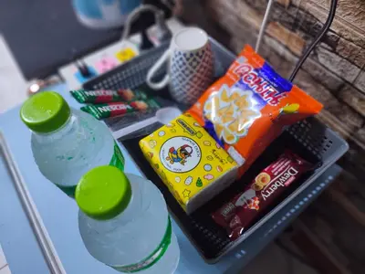 a table with two bottles of water and snacks at Jplace 101 Spacious Apartment with free Wi-fi in Bangkok