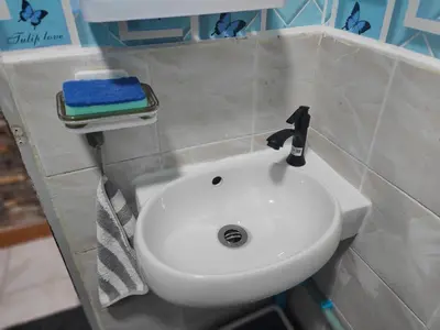 a bathroom with a white sink and a towel at Jplace 101 Spacious Apartment with free Wi-fi in Bangkok