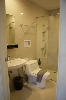 a bathroom with a toilet and a sink and a shower at Entire Townhome 3BR3B, Pool, Sukhumvit-EmSphere in Bangkok