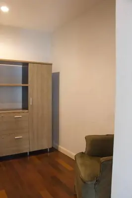 a living room with a chair and a dresser at Entire Townhome 3BR3B, Pool, Sukhumvit-EmSphere in Bangkok