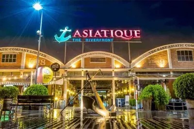 a building with a playground in front of it at night at Best river view - Loft apartment in great location in Bangkok