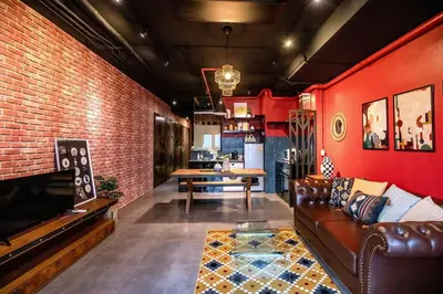 a living room with a couch and a brick wall at Best river view - Loft apartment in great location in Bangkok