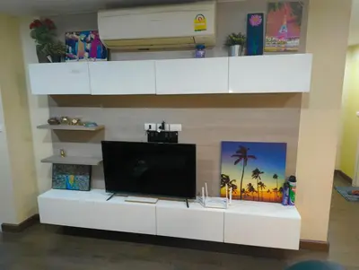 a living room with a tv on a white entertainment center at بانكوك سوكمفيت شارع 5 liv at 5 in Bangkok