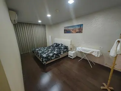 a bedroom with a bed and a table in it at بانكوك سوكمفيت شارع 5 liv at 5 in Bangkok
