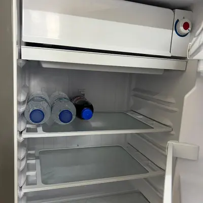 an open refrigerator with two bottles of water in it at Happy Daisy ห้องพัก เมืองทองธานี in Nonthaburi