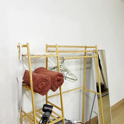 a towel rack next to a wall with a camera at Happy Daisy ห้องพัก เมืองทองธานี in Nonthaburi