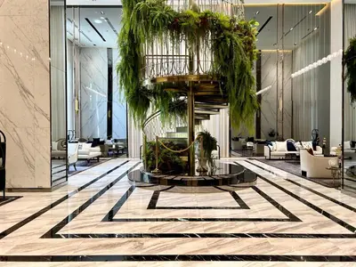 a lobby with a fountain with plants in it at The Address Siam Luxury Two Bedrooms in Bangkok