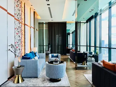 a lobby with couches and chairs in a building at The Address Siam Luxury Two Bedrooms in Bangkok