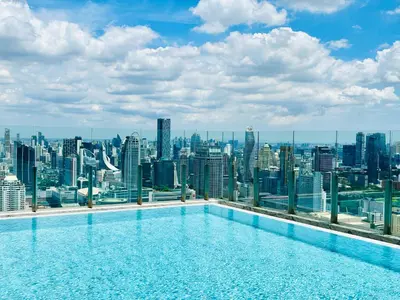 a swimming pool on the roof of a building with a city skyline at The Address Siam Luxury Two Bedrooms in Bangkok
