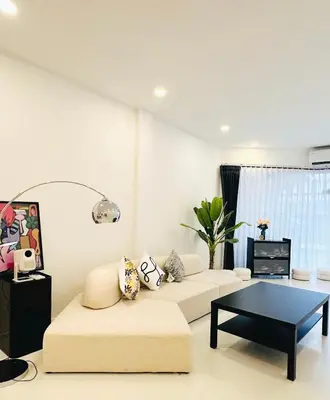 a living room with a couch and a coffee table at Fivehouse Silom2 soi11 City heart Silom BTS 7min in Bang Rak